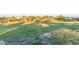 A well-manicured community green space with lush grass inviting relaxation and recreation at 3025 N Desert Horizons Ln, Casa Grande, AZ 85122