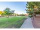 A serene community walking path winding through green space, lined with mature trees and landscaping at 3025 N Desert Horizons Ln, Casa Grande, AZ 85122