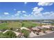 Expansive view of the neighborhood featuring lush green lawns, mature trees, and well-maintained homes at 3586 S Moccasin Trl, Gilbert, AZ 85297