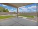Spacious covered patio overlooking a large backyard with manicured grass and stone accents at 3586 S Moccasin Trl, Gilbert, AZ 85297