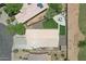 Overhead view of backyard with artificial turf, concrete patio with a dining set, and low maintenance desert landscaping at 3586 S Moccasin Trl, Gilbert, AZ 85297