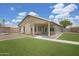 Backyard with patio, artificial turf, and covered patio at 3586 S Moccasin Trl, Gilbert, AZ 85297