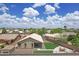 Aerial shot of the backyard featuring artificial turf, concrete patio with a dining set, and desert landscaping at 3586 S Moccasin Trl, Gilbert, AZ 85297