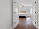 View into a bedroom with hardwood floors, a ceiling fan, and a bed with floral bedding at 3586 S Moccasin Trl, Gilbert, AZ 85297