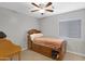 Cozy bedroom with a ceiling fan and window, featuring neutral gray walls at 3586 S Moccasin Trl, Gilbert, AZ 85297