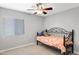 Bright bedroom features a ceiling fan, large window, and comfortable bed with stylish patterned bedding at 3586 S Moccasin Trl, Gilbert, AZ 85297