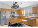 Spacious kitchen with stainless steel appliances, wooden cabinets, a large island, and tiled flooring at 3586 S Moccasin Trl, Gilbert, AZ 85297