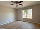 Bright bedroom with wood-look flooring and a large window offering a view of the outdoors at 3840 N 43Rd Ave # 34, Phoenix, AZ 85031