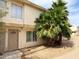 Charming townhome with desert landscaping, featuring mature palm trees for added curb appeal at 3840 N 43Rd Ave # 34, Phoenix, AZ 85031