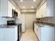 Updated kitchen with white cabinets, granite countertops, and stainless steel appliances for a modern look at 3840 N 43Rd Ave # 34, Phoenix, AZ 85031