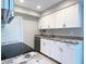 Beautifully renovated kitchen with white cabinetry, granite countertops, and modern stainless steel appliances at 3840 N 43Rd Ave # 34, Phoenix, AZ 85031