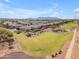 Aerial view showcasing a neighborhood near a lush green space and walking path at 40657 W Somers Dr, Maricopa, AZ 85138
