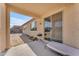 Covered back patio leads to desert landscaped yard at 40657 W Somers Dr, Maricopa, AZ 85138