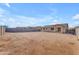 Spacious backyard with block fence and view of the rear of the single story home at 40657 W Somers Dr, Maricopa, AZ 85138