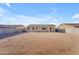 The home features a large dirt backyard with a wall offering plenty of space for recreation at 40657 W Somers Dr, Maricopa, AZ 85138