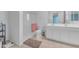 Bright bathroom features a dual sink vanity and walk-in shower with glass doors at 40657 W Somers Dr, Maricopa, AZ 85138
