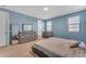 Calming bedroom with blue walls, a dresser and a crib at 40657 W Somers Dr, Maricopa, AZ 85138