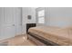 Neutral bedroom has carpet, closet, and natural lighting through the window at 40657 W Somers Dr, Maricopa, AZ 85138
