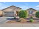 Charming single-story home featuring a two-car garage and desert landscaping at 40657 W Somers Dr, Maricopa, AZ 85138