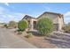 Charming single-story home featuring manicured landscaping and stone accents at 40657 W Somers Dr, Maricopa, AZ 85138