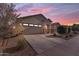 Beautiful exterior view of a single-story home with desert landscaping at dusk at 40657 W Somers Dr, Maricopa, AZ 85138