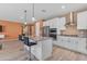 Open concept kitchen featuring island with bar seating and stainless steel appliances at 40657 W Somers Dr, Maricopa, AZ 85138