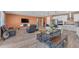 Spacious living room featuring wood flooring, dining area, and access to kitchen at 40657 W Somers Dr, Maricopa, AZ 85138