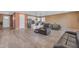 Expansive living room with wood floors, seamlessly flowing into the open kitchen at 40657 W Somers Dr, Maricopa, AZ 85138