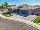 An aerial view showing the home's three-car garage, manicured lawn, and stylish design at 4236 S John Way, Chandler, AZ 85249