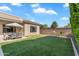 This backyard features artificial turf, an outdoor seating area, and mature landscaping, a relaxing outdoor retreat at 4236 S John Way, Chandler, AZ 85249