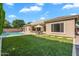 Inviting backyard features lush artificial turf, and a refreshing pool, ideal for outdoor relaxation at 4236 S John Way, Chandler, AZ 85249