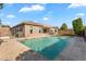 Backyard with a pool, tiled patio, grass and blue skies at 4236 S John Way, Chandler, AZ 85249