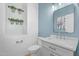 Stylish bathroom featuring a sleek vanity, modern mirror, and decorative wall plants at 4236 S John Way, Chandler, AZ 85249