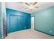 Bedroom with blue walls, closet, carpet and neutral ceiling fan at 4236 S John Way, Chandler, AZ 85249