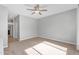 Spacious bedroom with a ceiling fan and neutral carpeting offers a blank canvas for personalized decor at 4236 S John Way, Chandler, AZ 85249