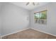Simple bedroom with ceiling fan, window and carpeted floor at 4236 S John Way, Chandler, AZ 85249