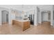 Spacious kitchen with a large center island, white cabinets, and stainless steel appliances at 4236 S John Way, Chandler, AZ 85249
