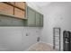 Laundry room with green cabinets and tile flooring at 4236 S John Way, Chandler, AZ 85249