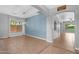Spacious living room with modern light fixture, tile floors, arched entryway, and view to the backyard at 4236 S John Way, Chandler, AZ 85249