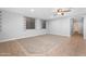 Large living area with tile floors, ceiling fan, and multiple windows that bring in natural light at 4236 S John Way, Chandler, AZ 85249