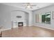Inviting living room with a fireplace, lots of natural light, and seamless flow to the kitchen area at 4236 S John Way, Chandler, AZ 85249