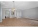 Open-concept living room with tile flooring, contemporary lighting, arched entryway, and neutral color palette at 4236 S John Way, Chandler, AZ 85249