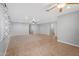 Spacious living room showcasing neutral walls, tile floors, and a partial carpet at 4236 S John Way, Chandler, AZ 85249