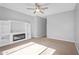 Cozy living room with a fireplace, built-in shelving, and plush carpeting creates a warm and inviting atmosphere at 4236 S John Way, Chandler, AZ 85249