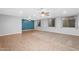 Expansive living space featuring tile and carpet flooring, ceiling fans, and bright windows at 4236 S John Way, Chandler, AZ 85249