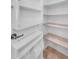 Walk-in pantry features bright white shelving providing ample storage space for all your culinary needs at 4236 S John Way, Chandler, AZ 85249