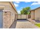 View of the side yard showing a gated entrance to the backyard and gravel ground cover at 4236 S John Way, Chandler, AZ 85249