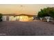 Backyard view featuring a covered patio and desert landscaping provides an inviting outdoor space at 434 N 56Th St, Mesa, AZ 85205