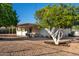 Private backyard oasis showcases a charming covered patio, mature trees, and low-maintenance desert landscaping at 434 N 56Th St, Mesa, AZ 85205