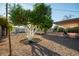Expansive backyard featuring mature citrus trees, gravel landscaping, and a covered patio for serene outdoor living at 434 N 56Th St, Mesa, AZ 85205